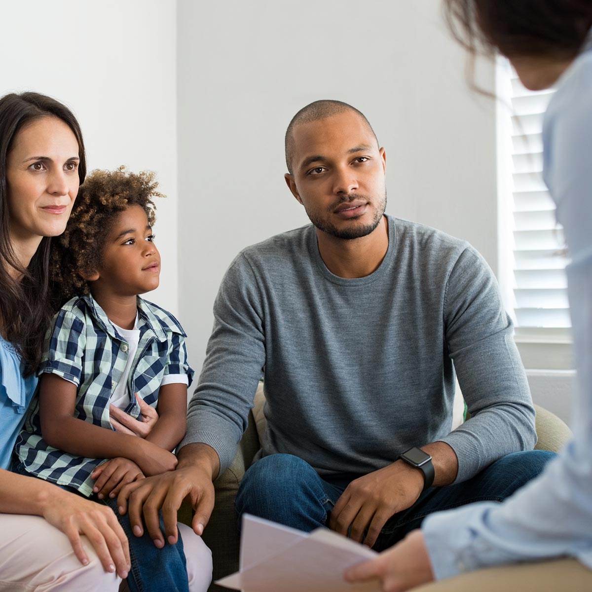 family in room talking with someone