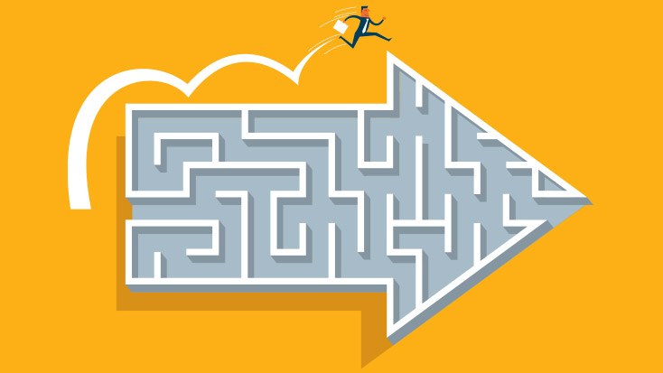 Image of someone jumping over a maze that is shaped like an arrow.