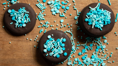 Chocolate cookies covered in blue sprinkles