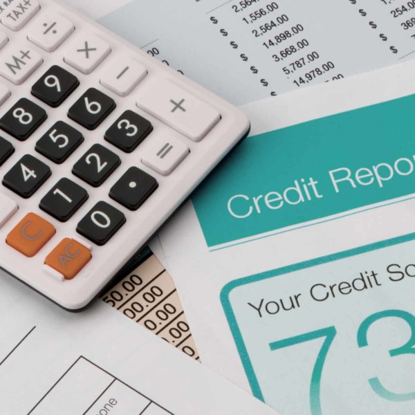 Close-up of a calculator and a credit report