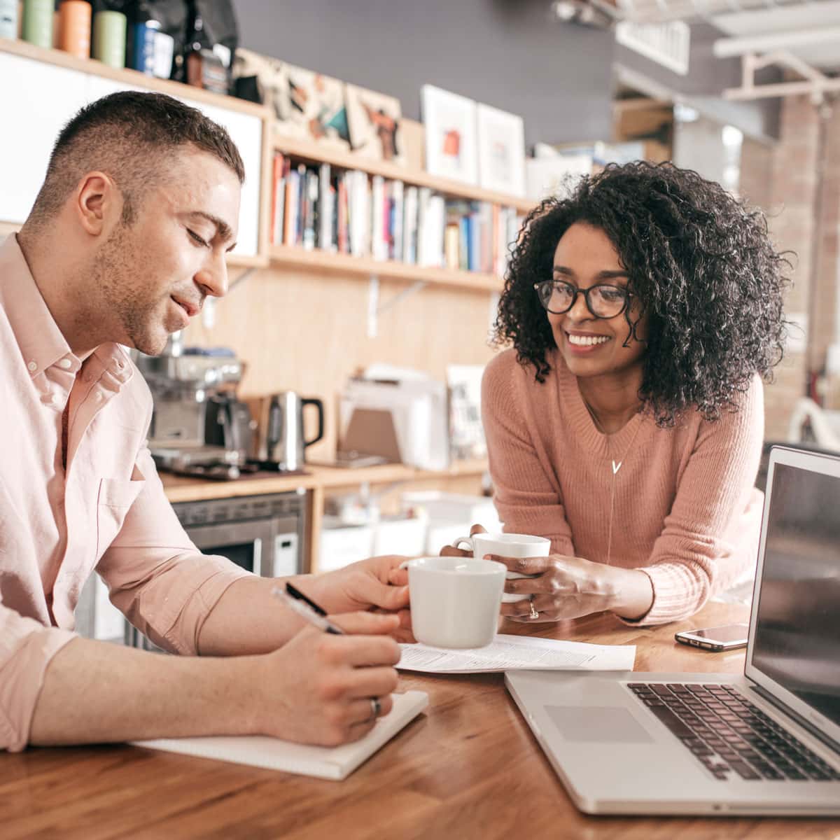 Couple drinking coffee and looking over the costs of a new home