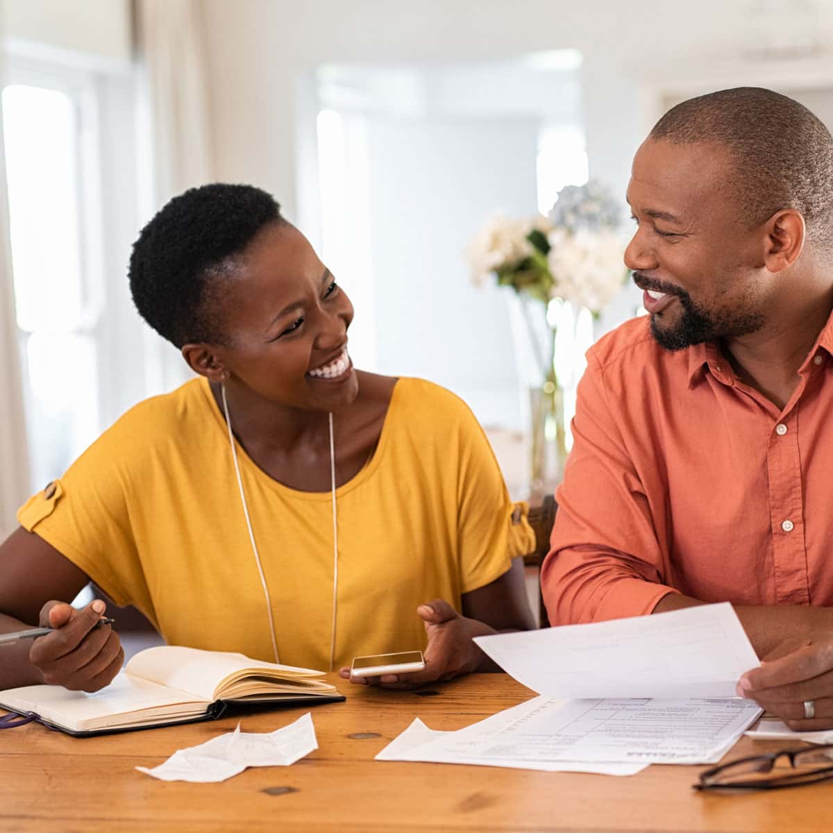 Couple looking through papers to check their spending