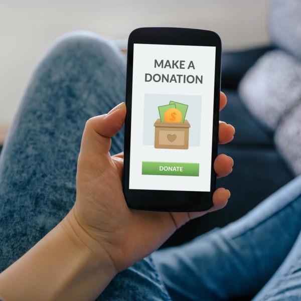 person donating to a charity via their phone
