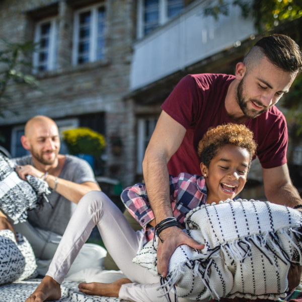 parents and their son outside having a picnic and relaxing