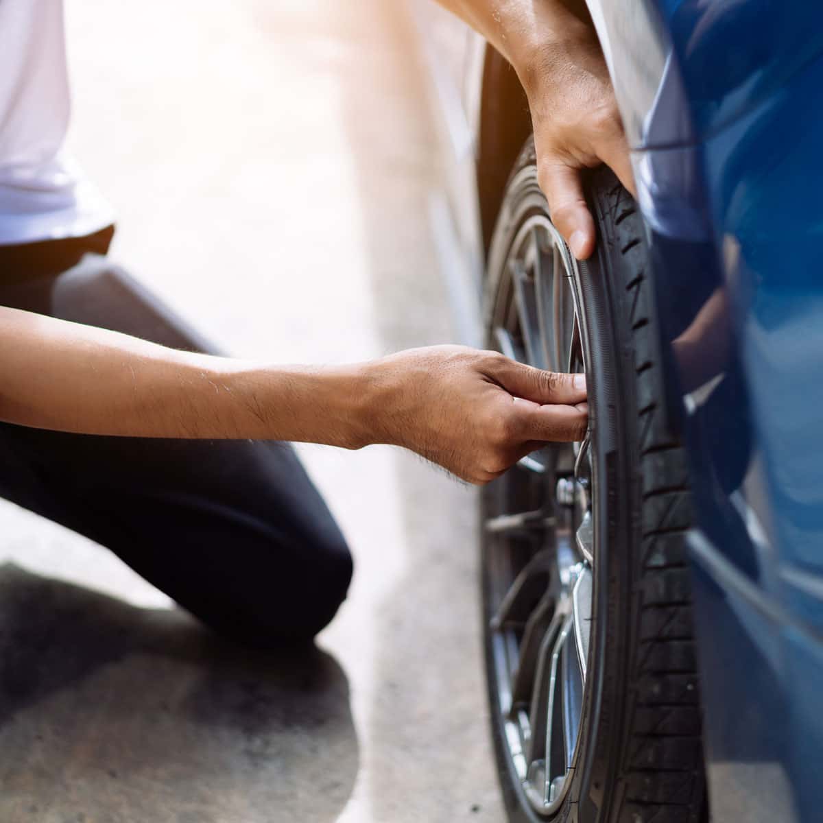 person fixing their tire