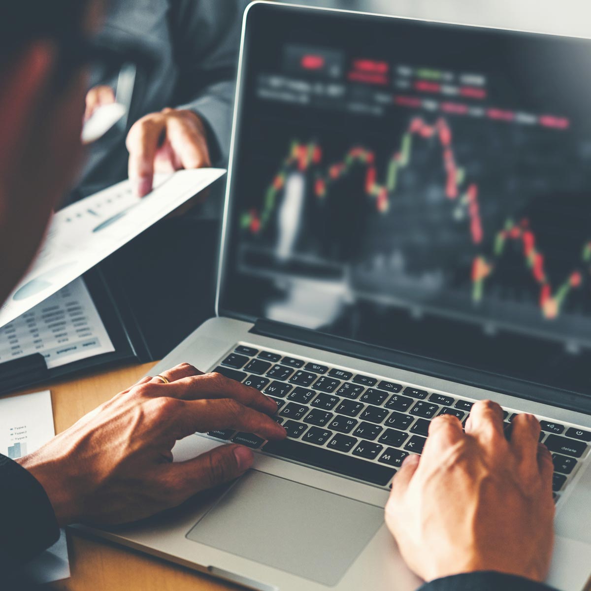 Man looking at investments over time on a laptop