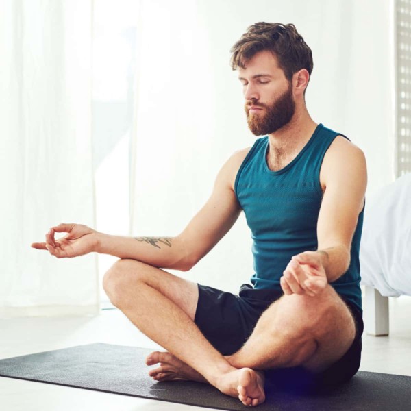 man meditating on a yoga mat
