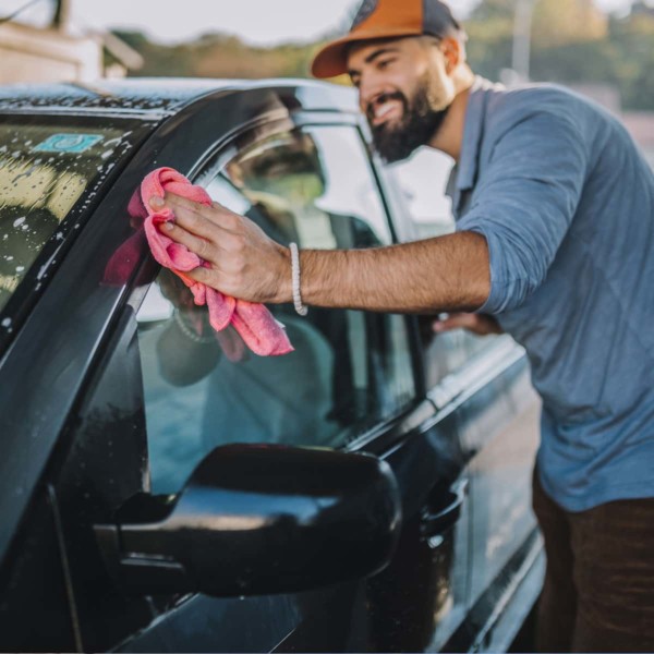 man washing his car by hand