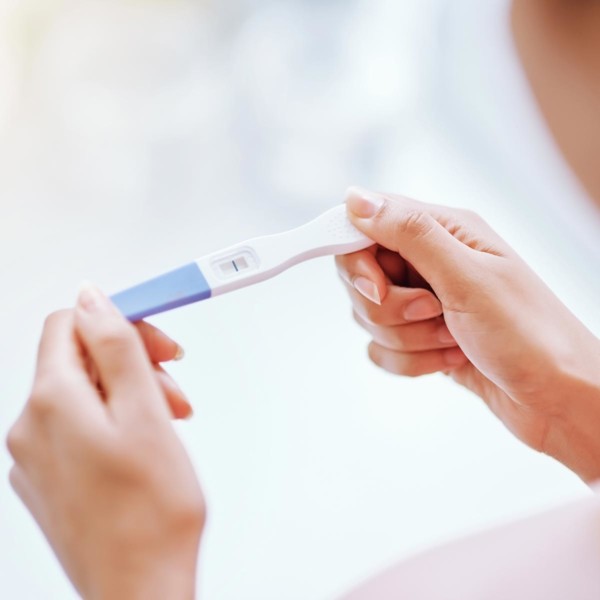 women looking at a pregnancy test