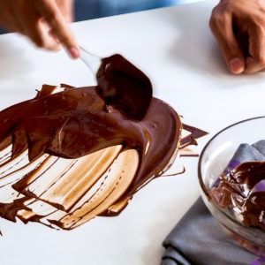 Smoothing melted chocolate across the table
