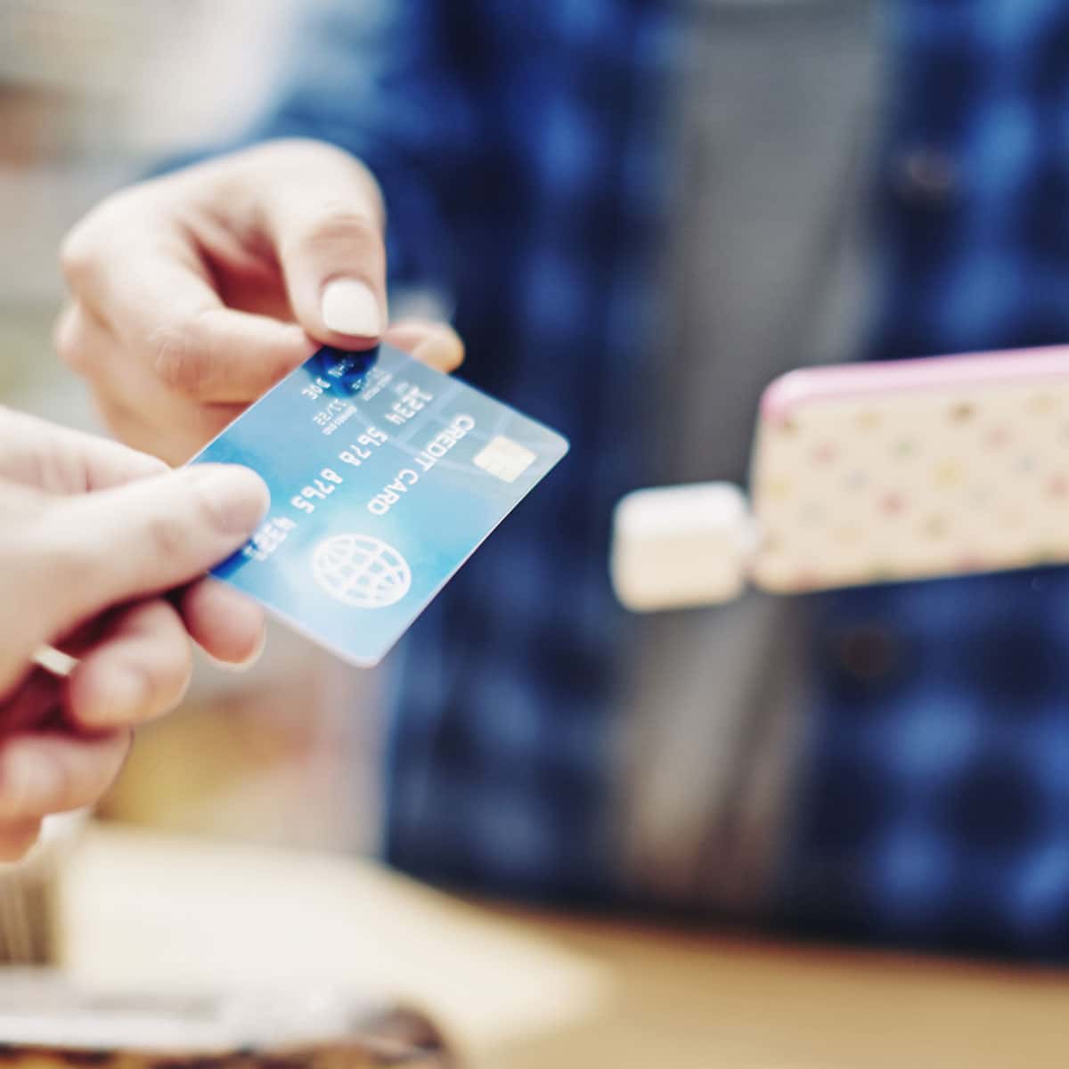 Someone handing someone a credit card