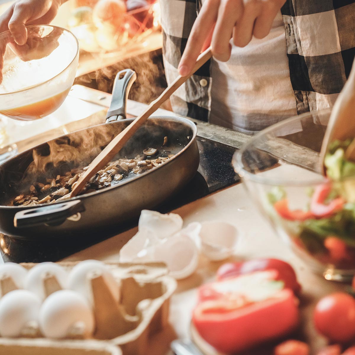 Image of someone cooking on a stove.