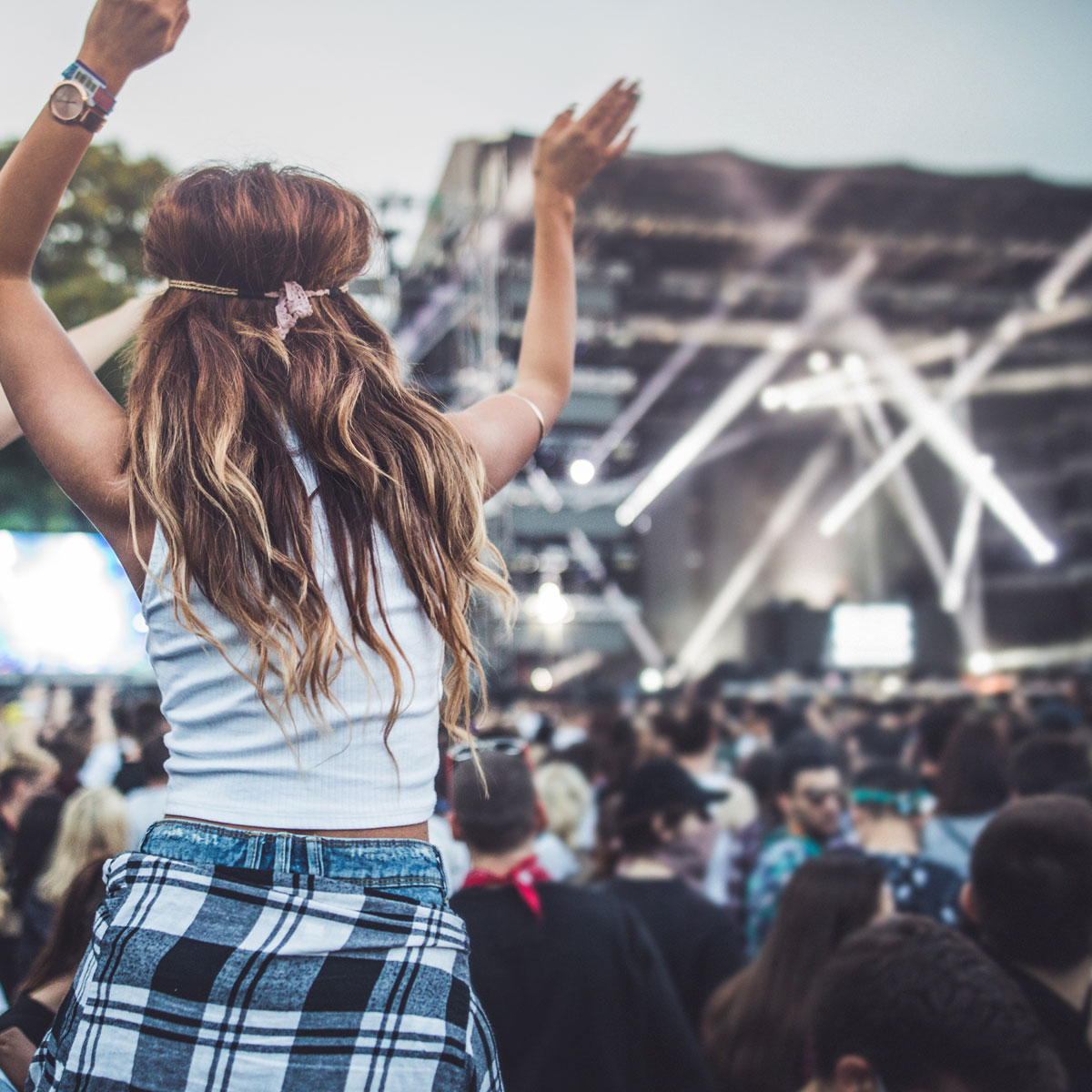 women at music festival in crowd cheering