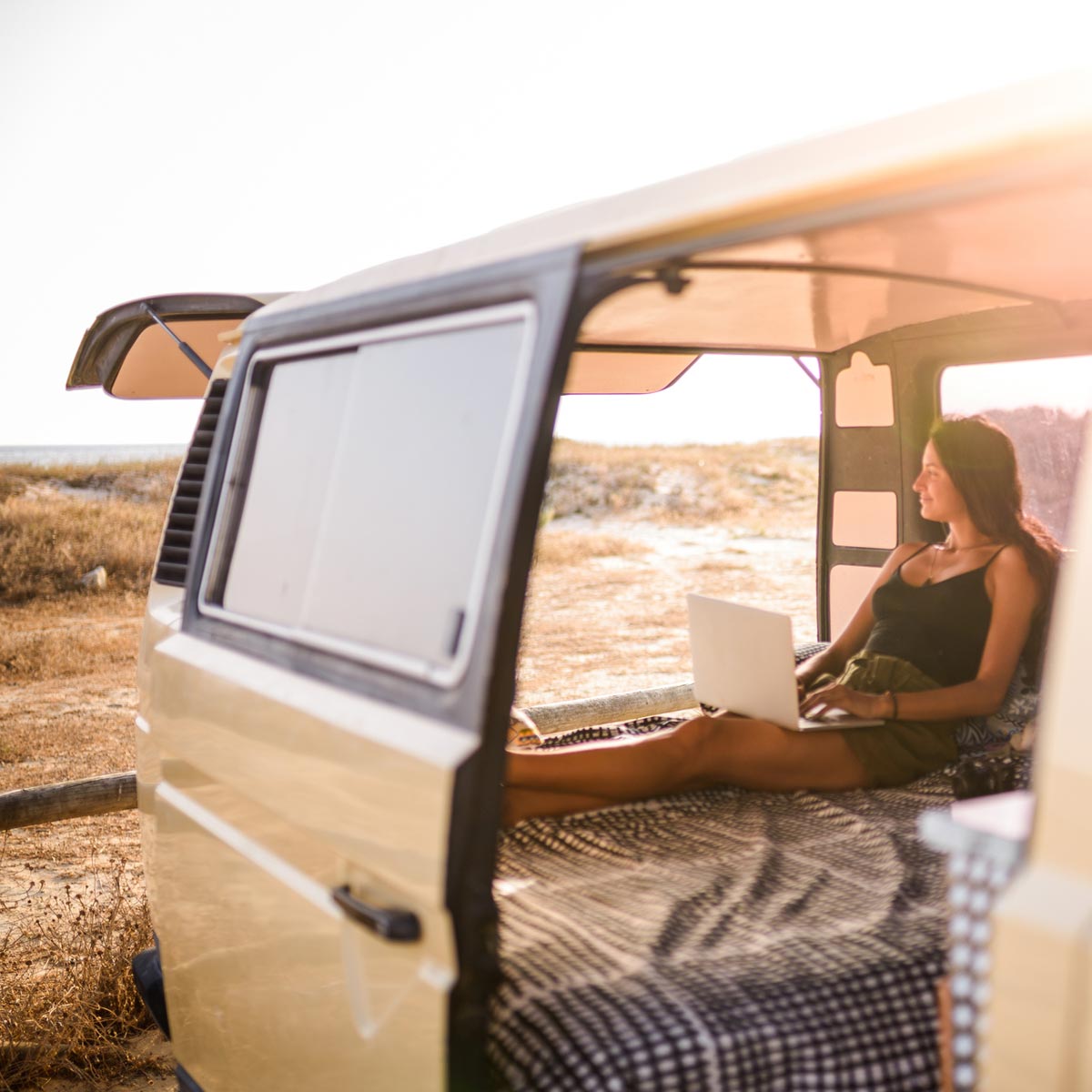 women working outdoors in her car