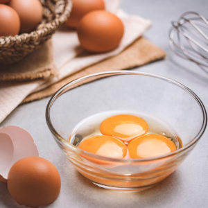 image of three eggs cracked in a bowl