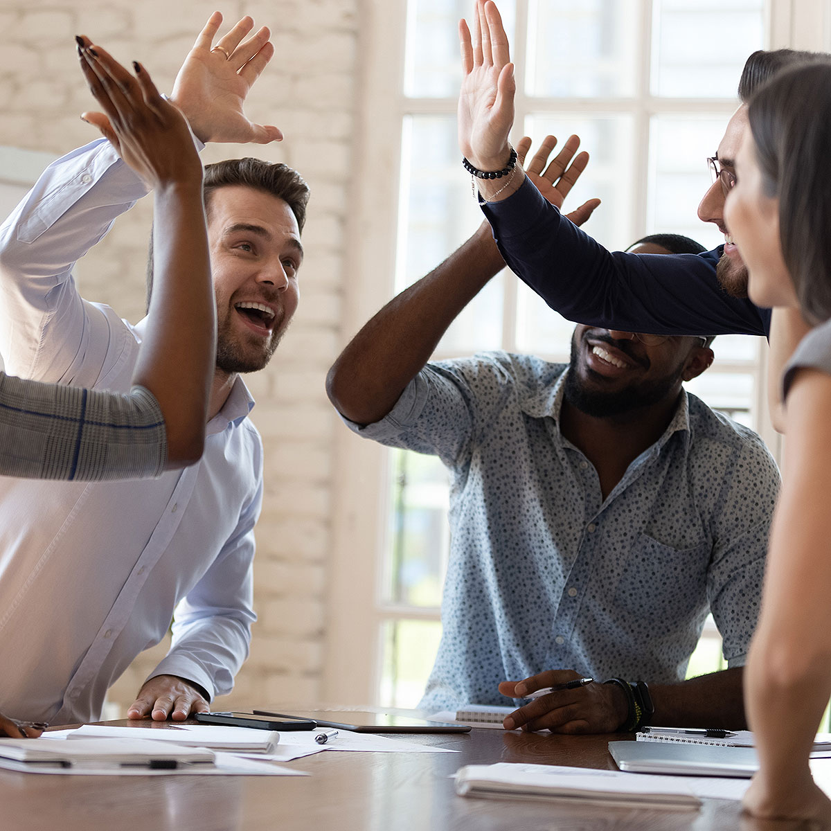 image of friends celebrating success during meeting