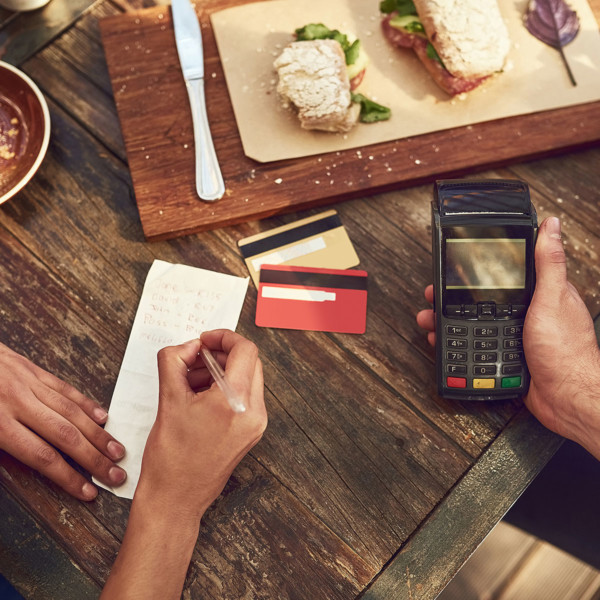 Splitting the check with a calculator after hanging out with friends
