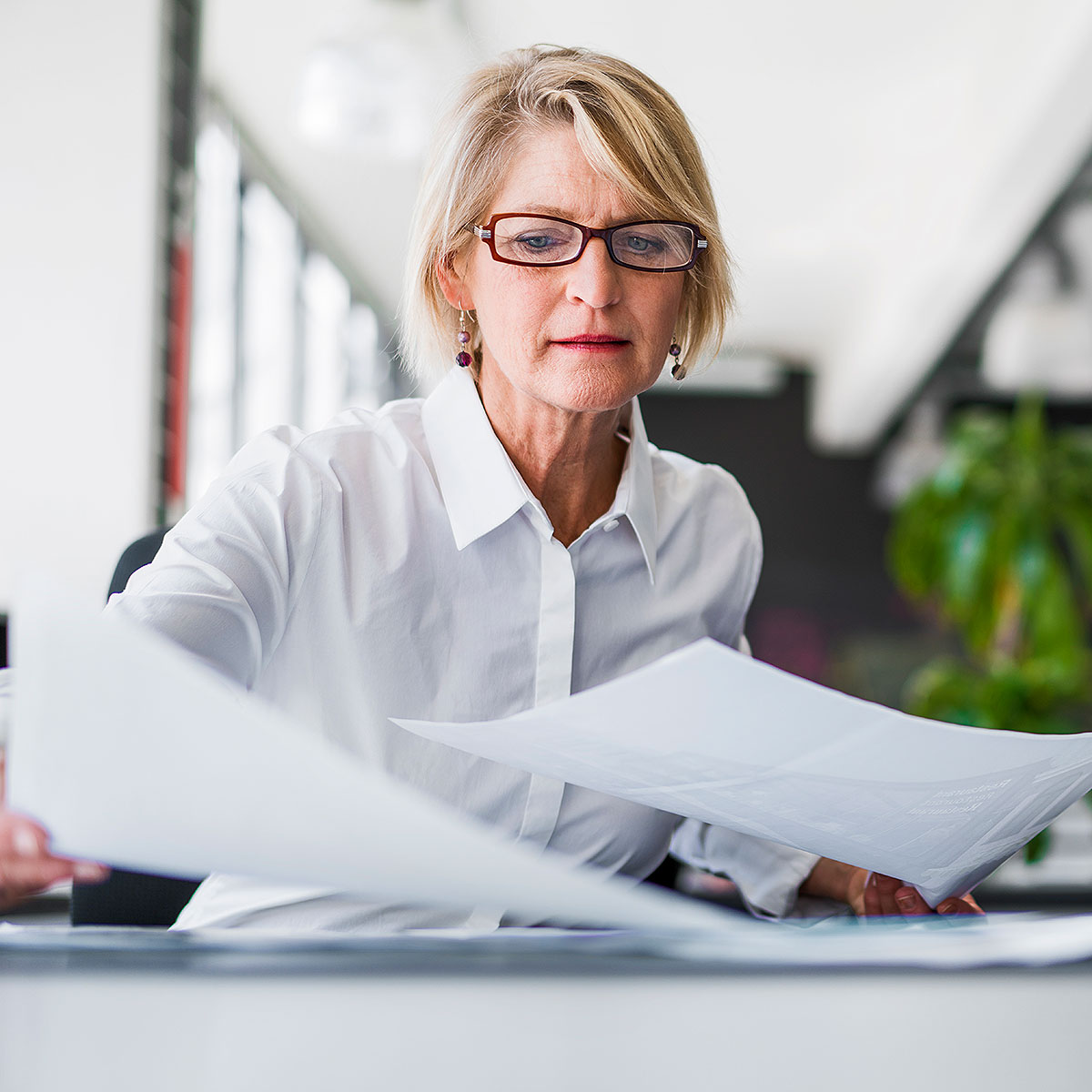 image of woman sifting through papers on desk