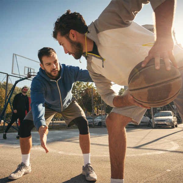 Friends playing basketball outside