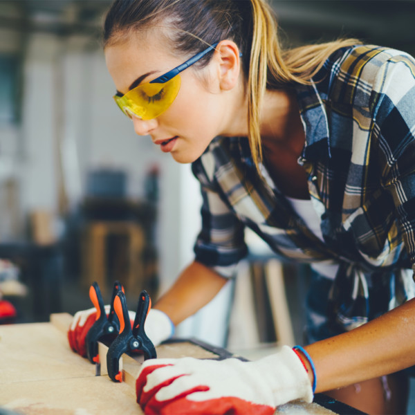 Woman working with wood in workshop