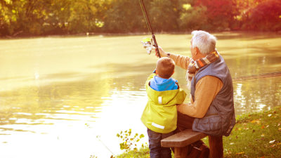 image of child fishing with grandfather