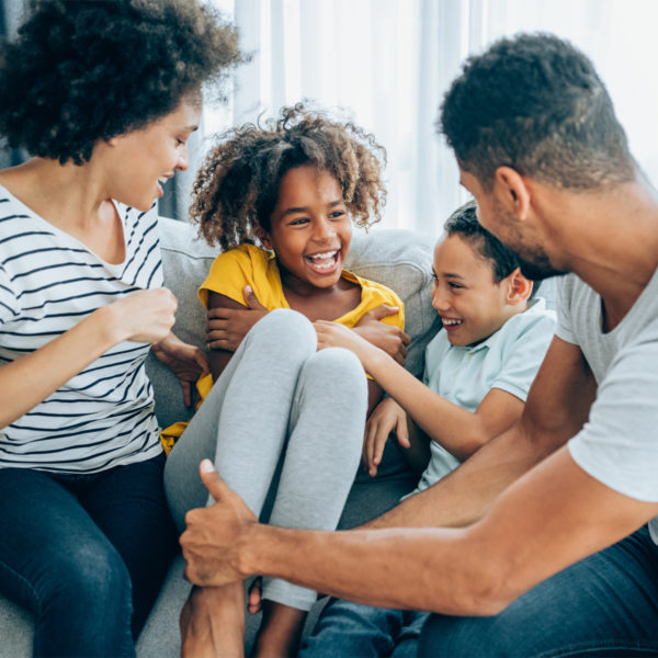 Image of a family laughing on the couch