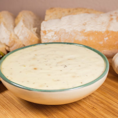 Image of a sliced bread and a bowl of garlic aioli sauce