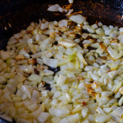 Onions sauteed in saucepan for chicken and rice dish